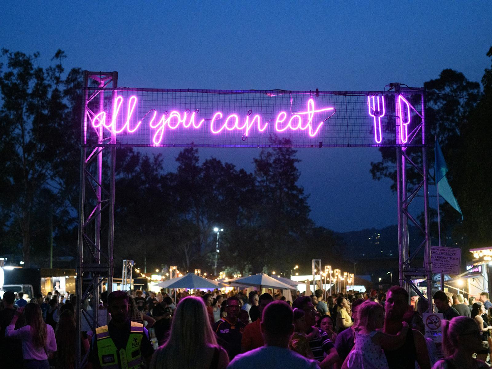 Neon sign over food stall area at Real Festival