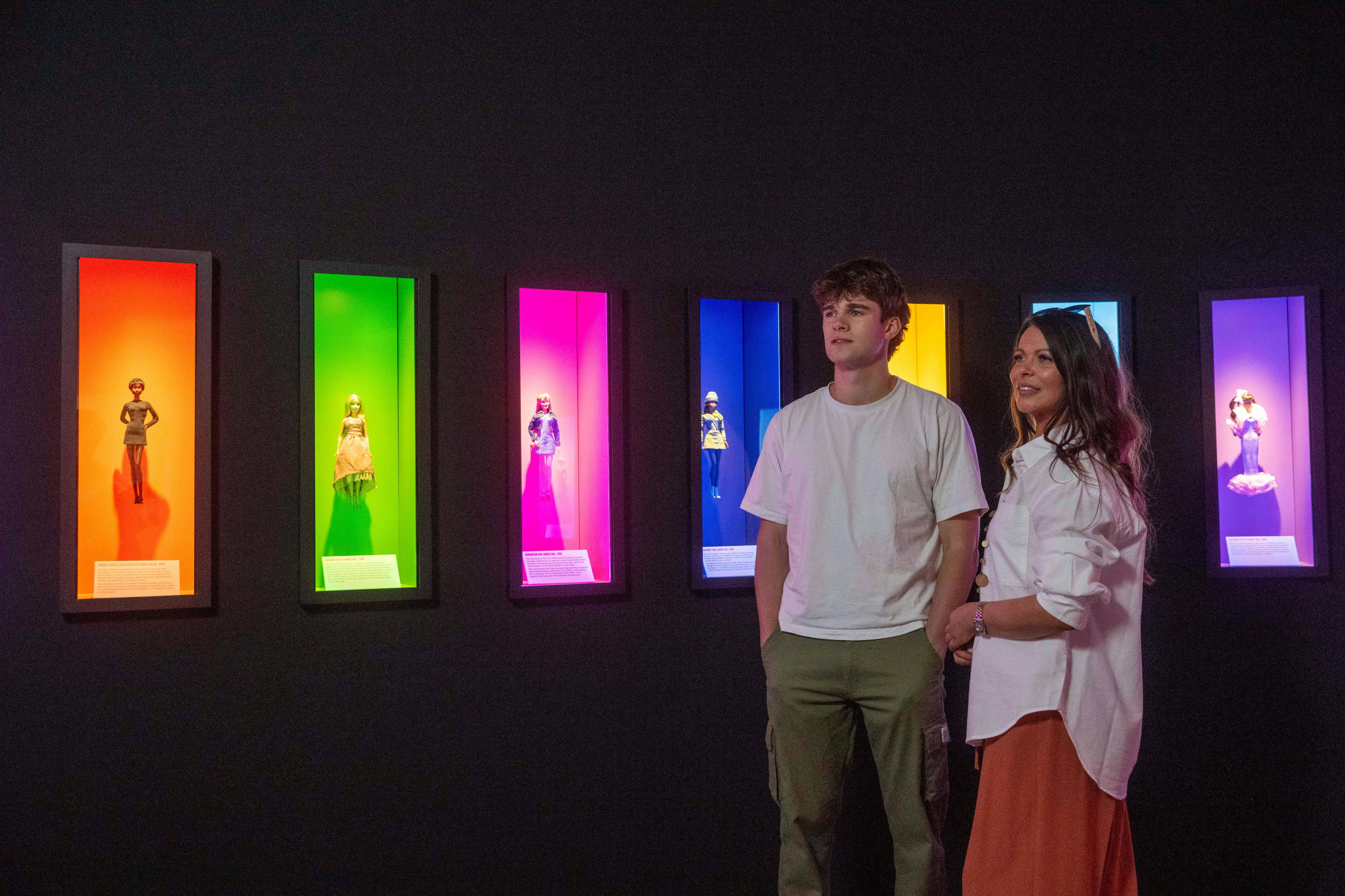 People exploring Barbie: The Exhibition .