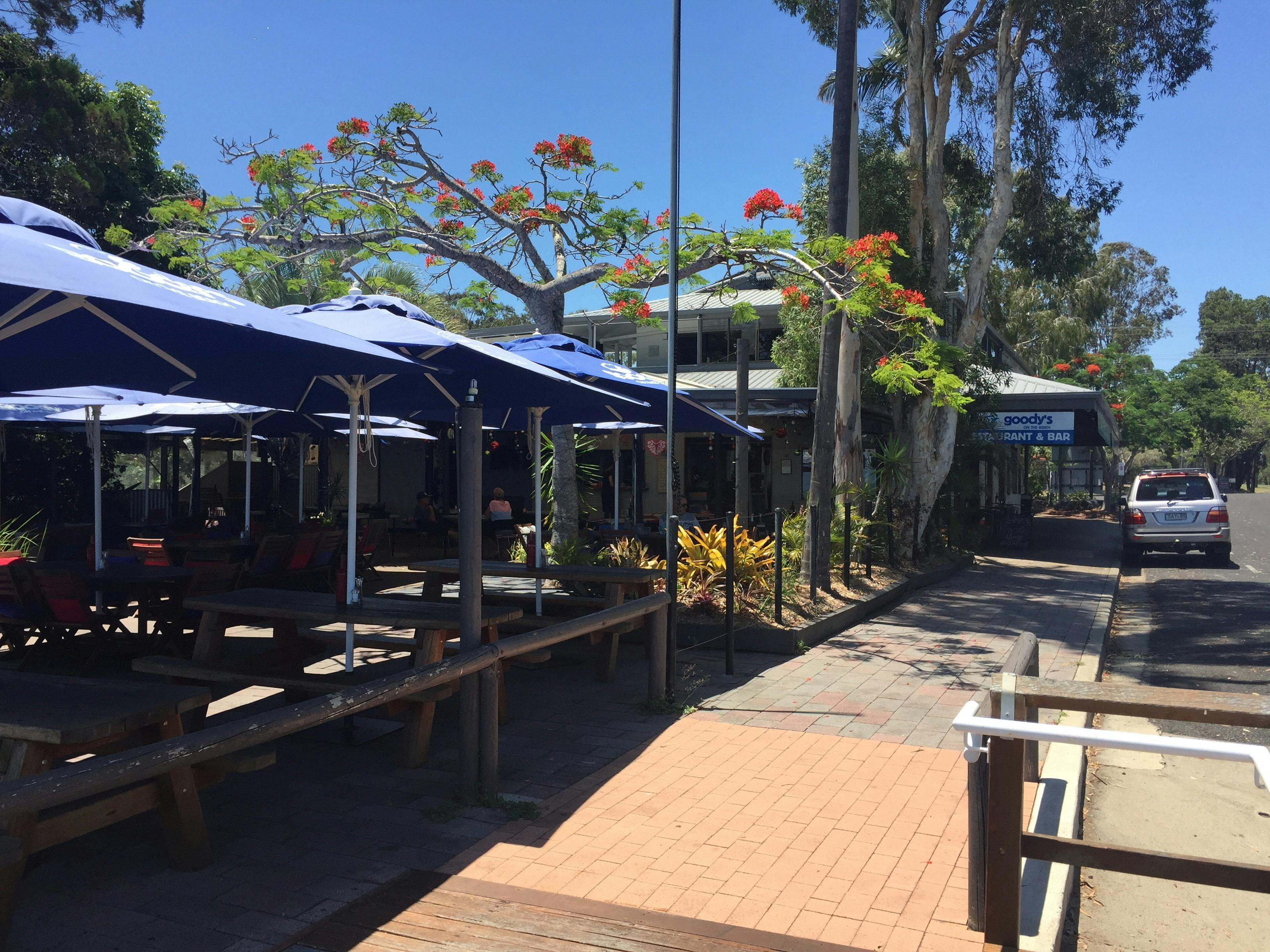 photo of the front seaside outdoor eating area shaded with large market umbrellas