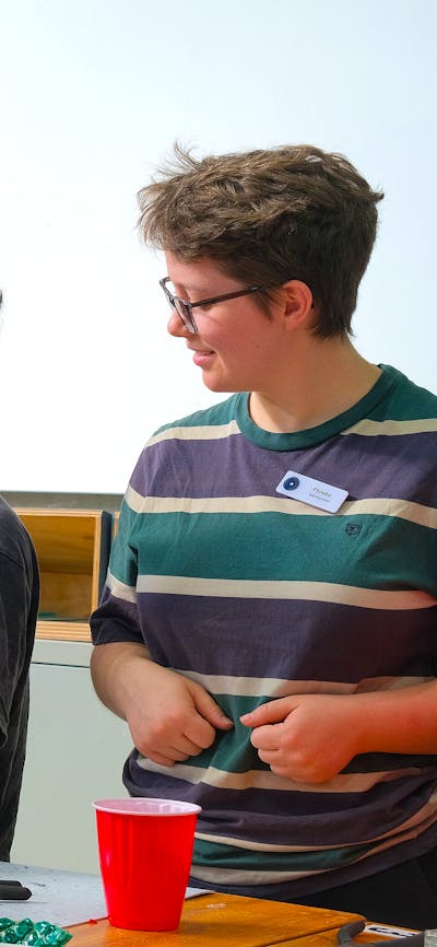 Participants smiling and cutting glass in Glassworks Engine Room