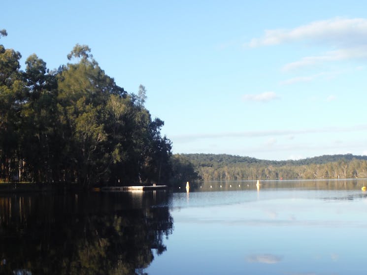 A channel of water with trees on both sides on the Myall Lakes Kayak Adventure