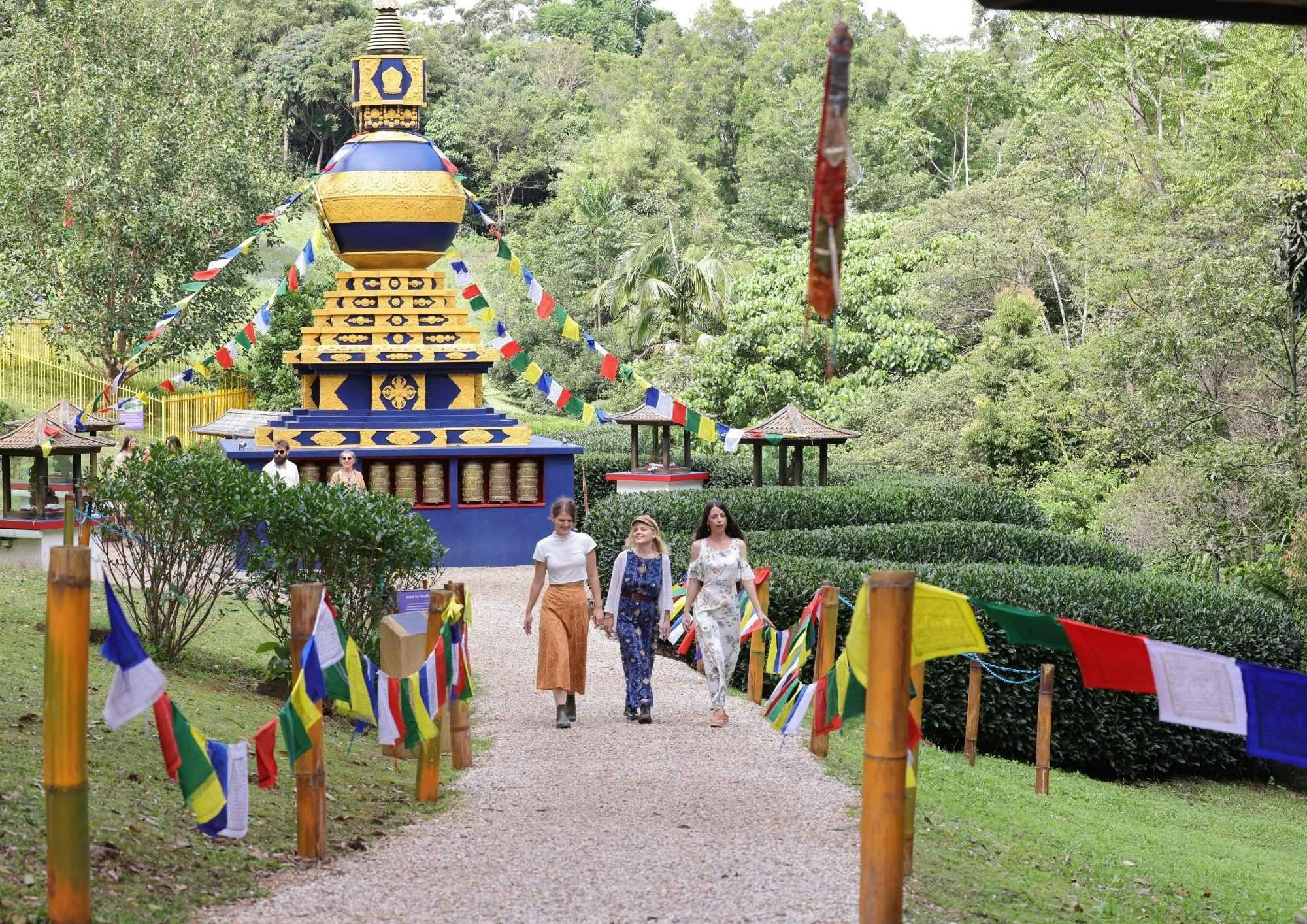 Three friends walking away from the World Peace Stupa, a sacred Tibetan Buddhist Monument