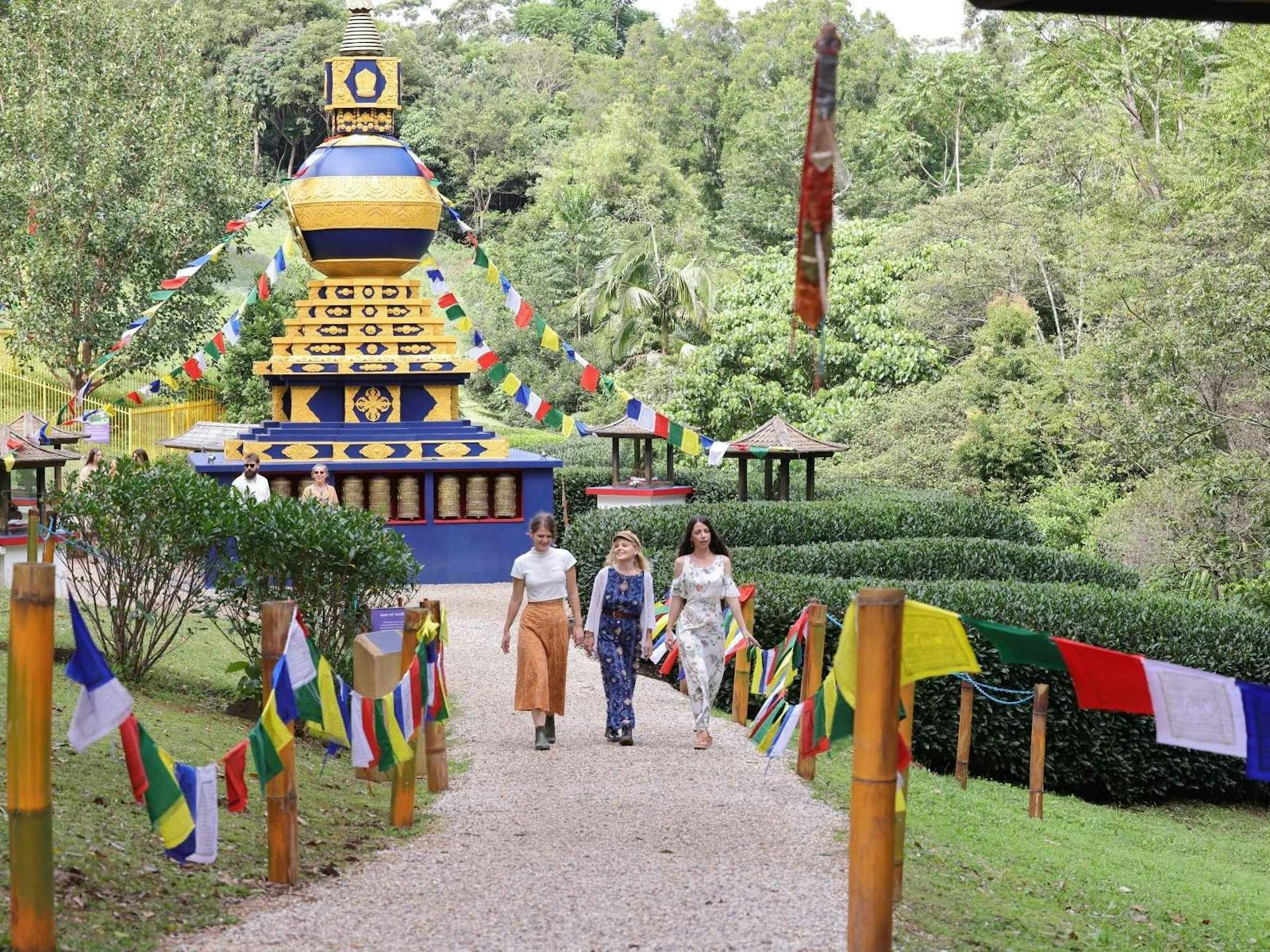 Three friends walking away from the World Peace Stupa, a sacred Tibetan Buddhist Monument