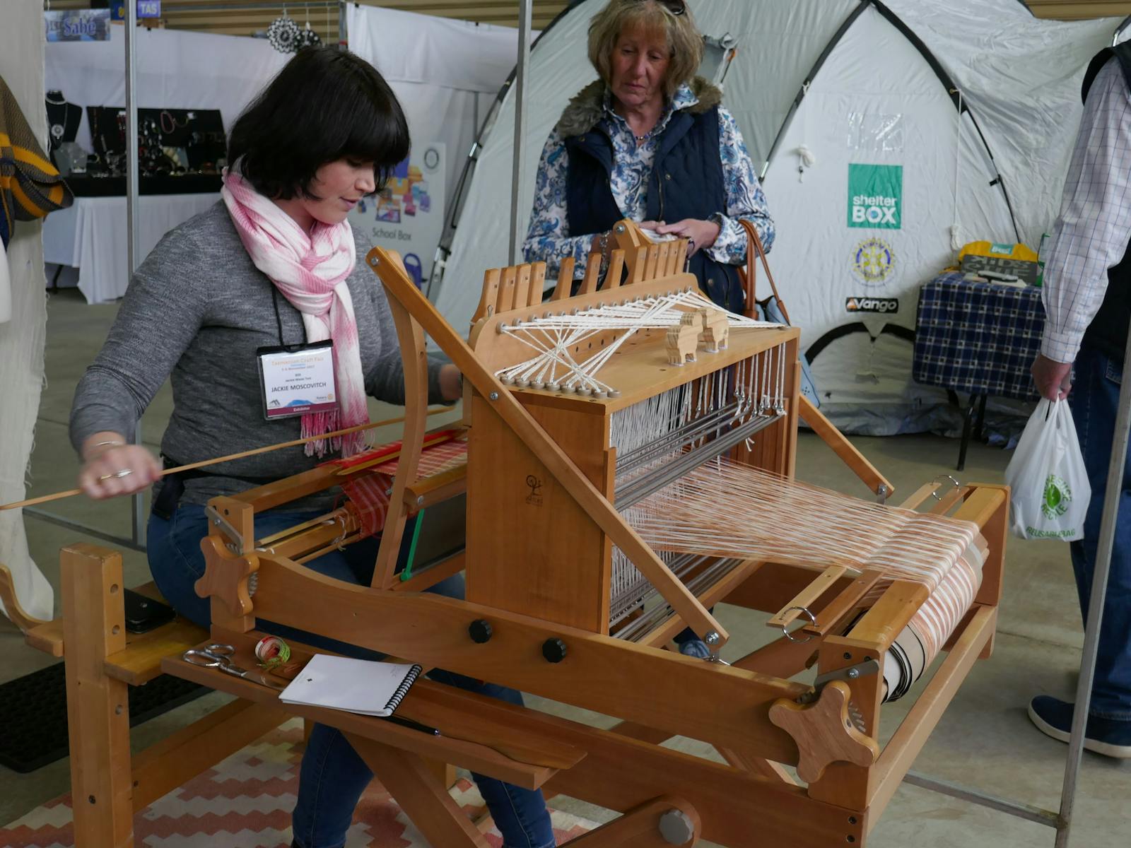 Exhibitor displaying weaving at Tasmanian Craft Fair