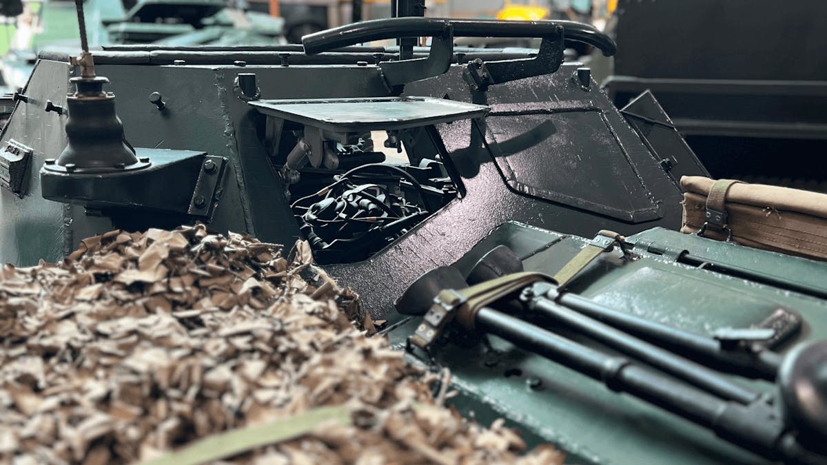 External of military vehicle with camo netting and military additions