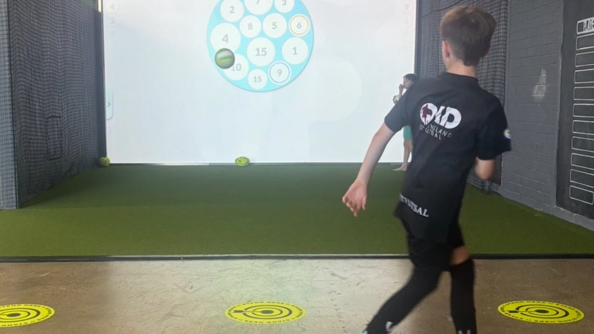Junior soccer player kicking a ball at targets during interactive sports games at MultiMatch Clevela