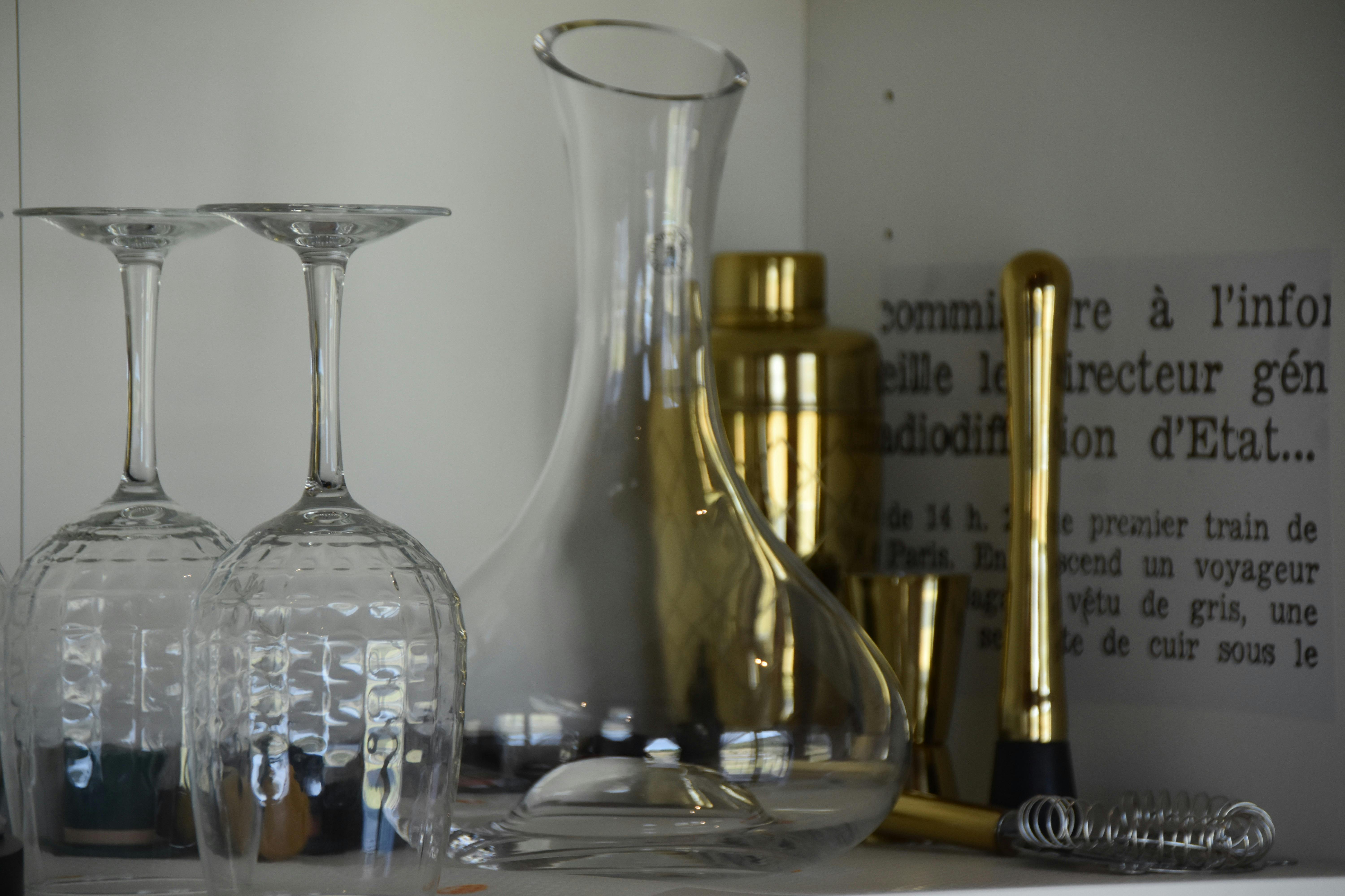 Glassware, decanter and bar tools arranged on shelf inside Anwen tiny home
