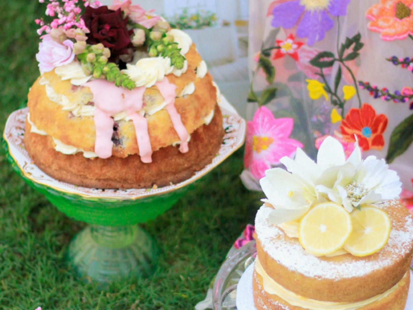 beautiful cakes on cake stands on the lawn