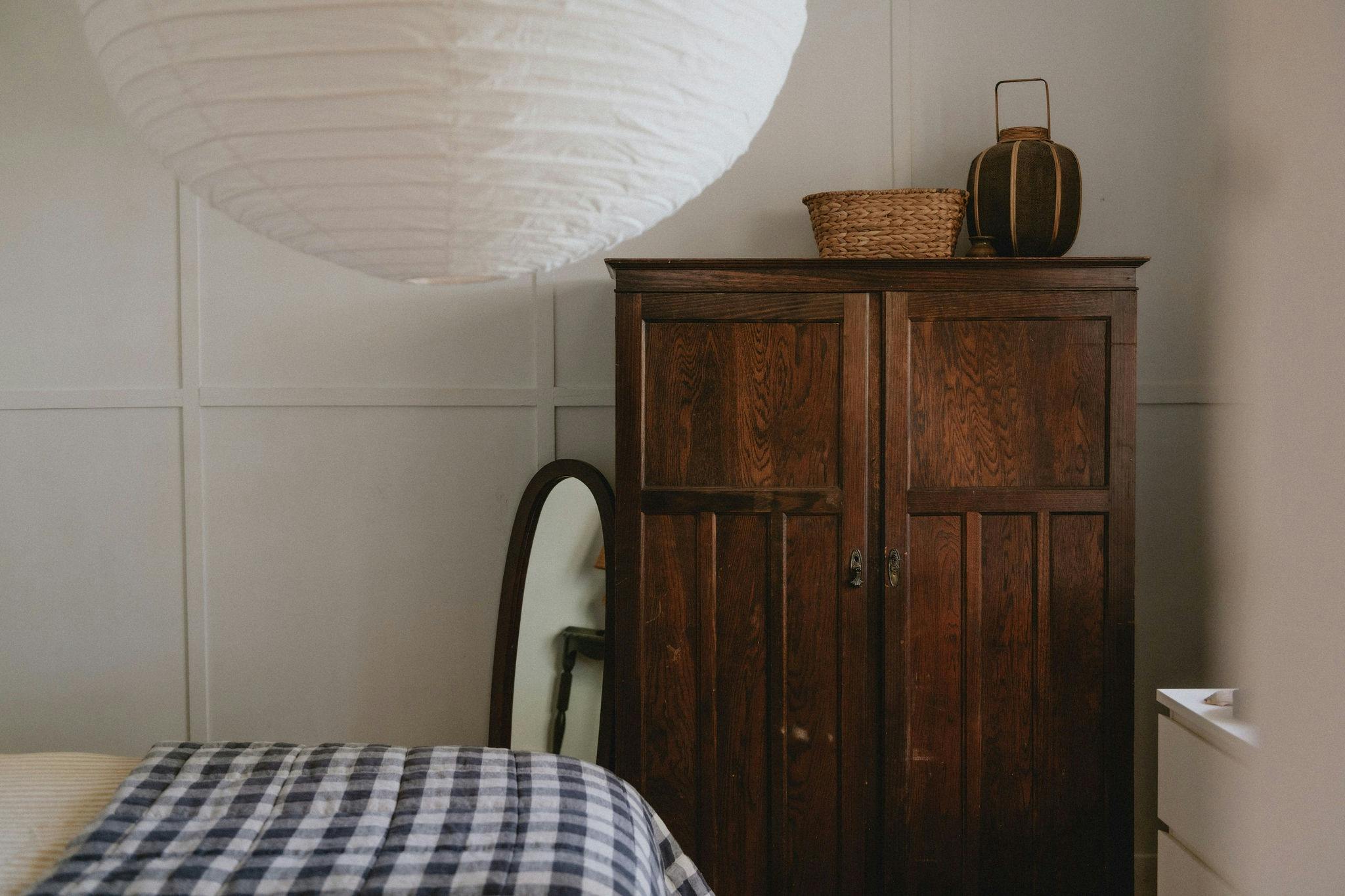 Bedroom one featuring a queen size bed draped in luxurious French linen.