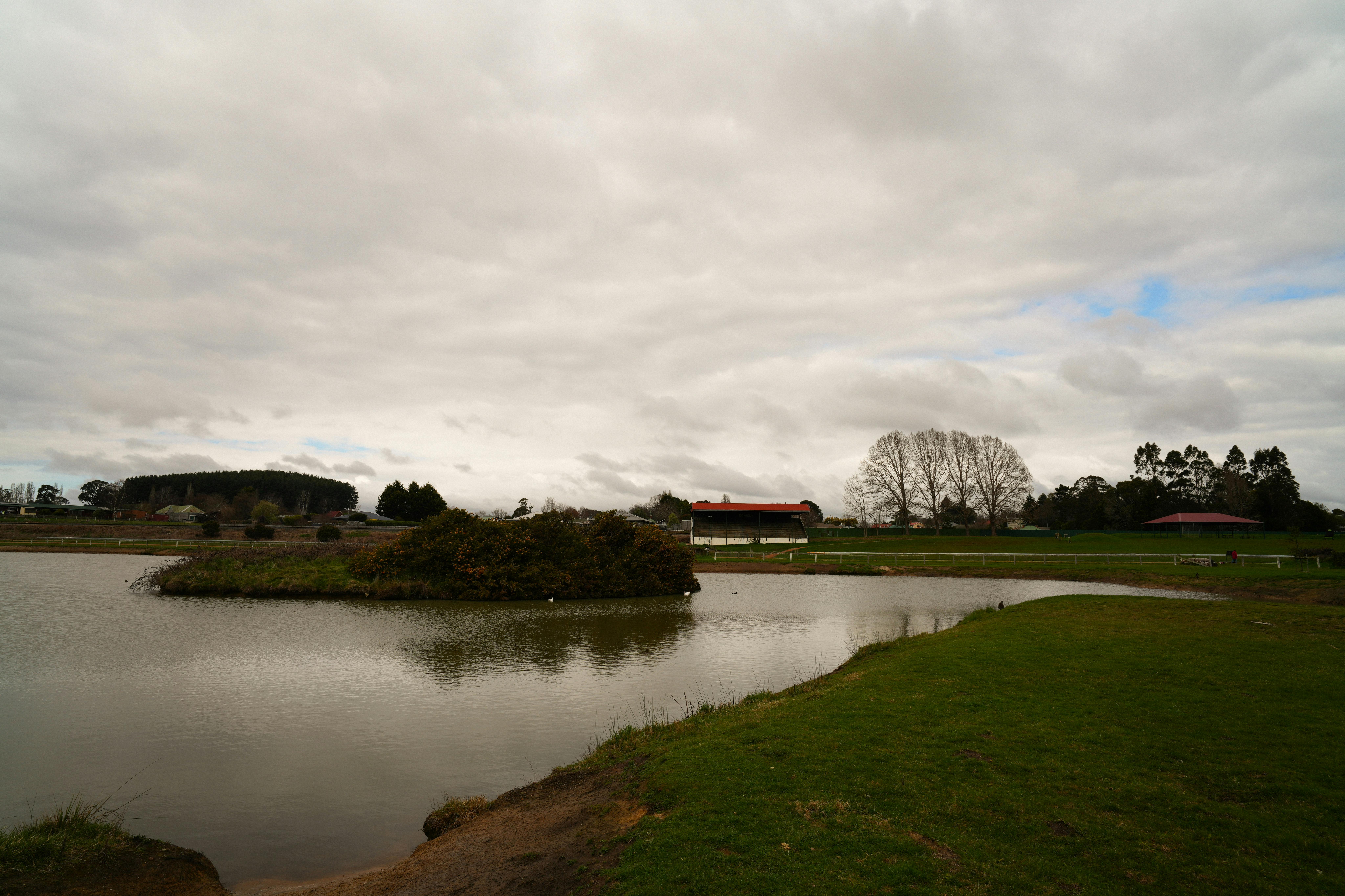A small lake with an island in it.