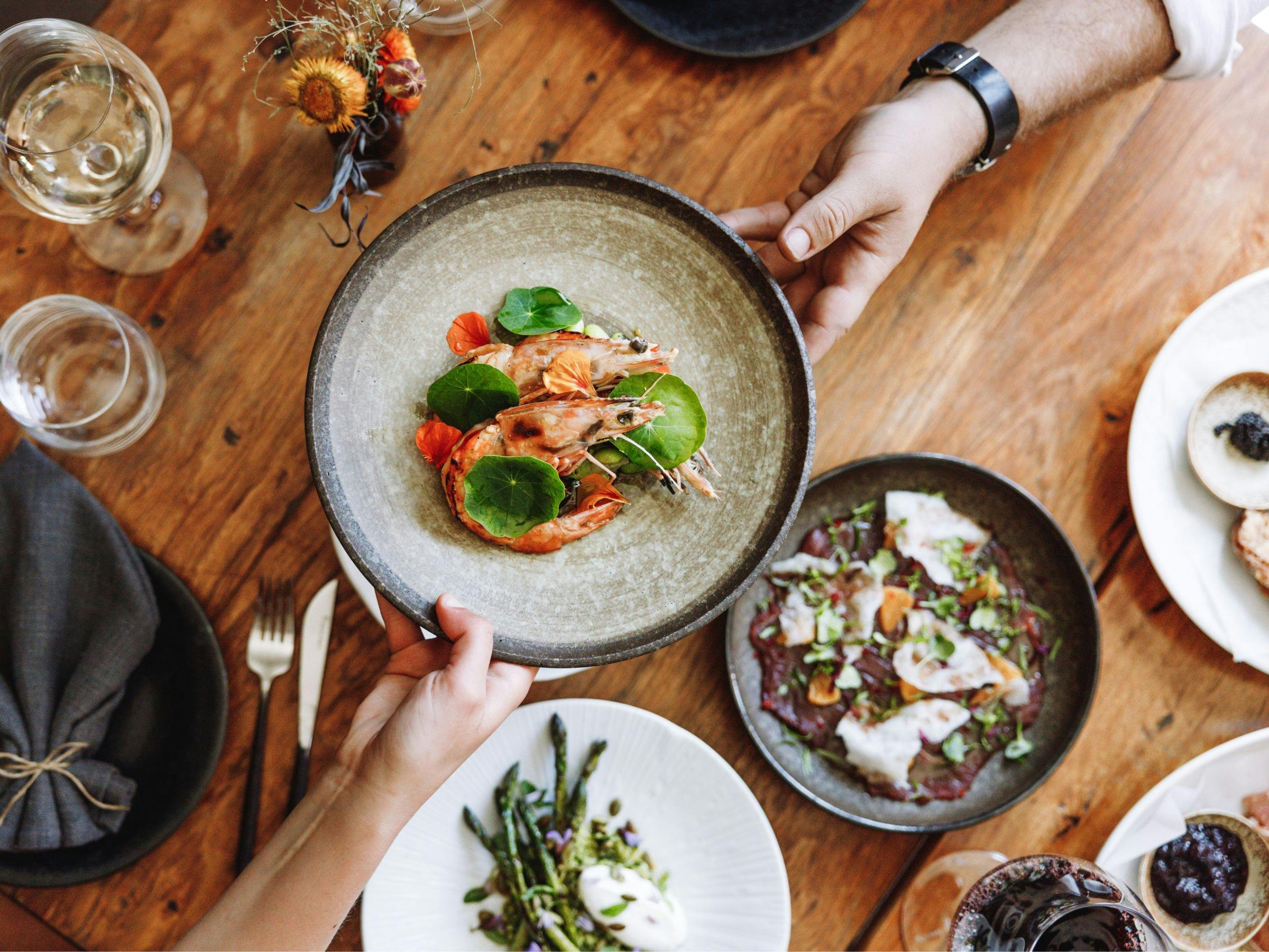 An image of food on the table at Elm Dining with King Prawns at the forefront