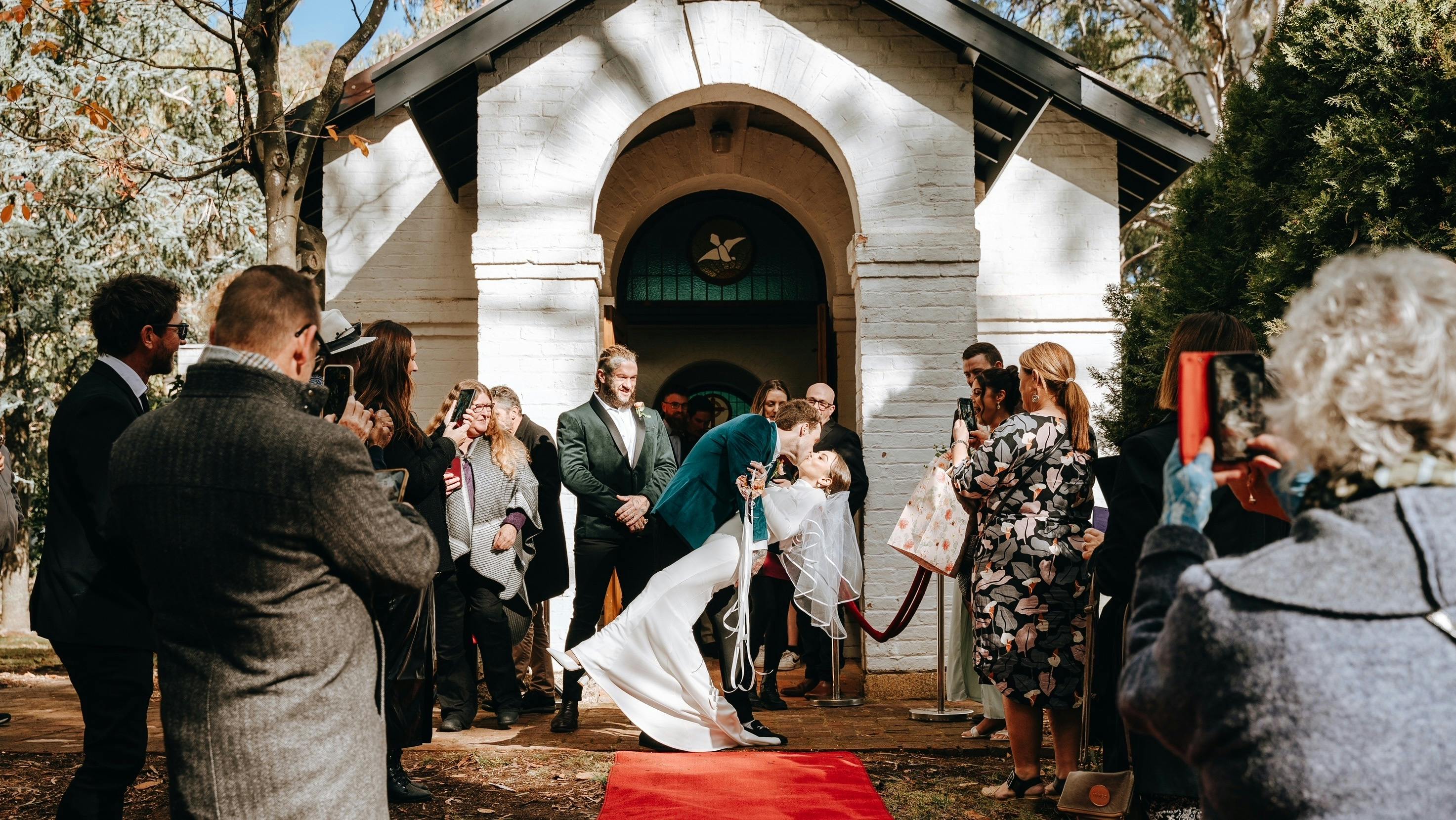 Wedding couple embrace at Chapel entrance