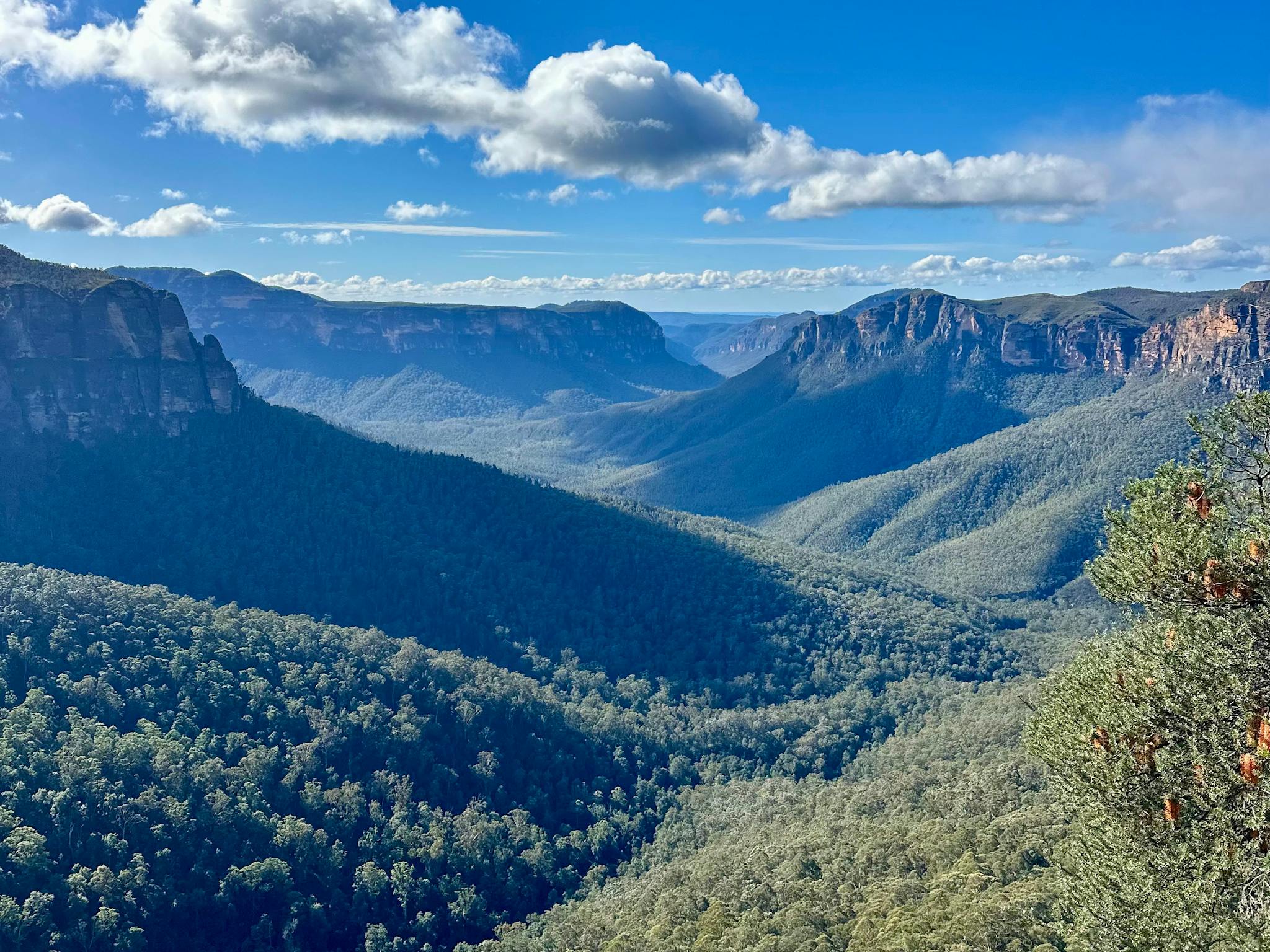 Green rolling mountains and blue skies above.