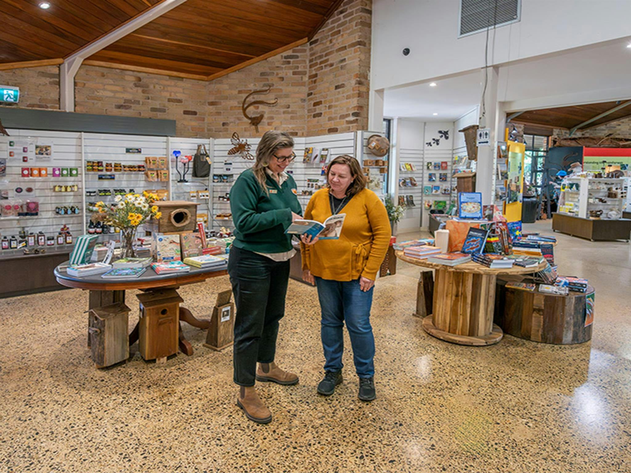 Staff helping a visitor at Dorrigo Rainforest Centre. Photo: John Spencer/DCCEEW © DCCEEW
