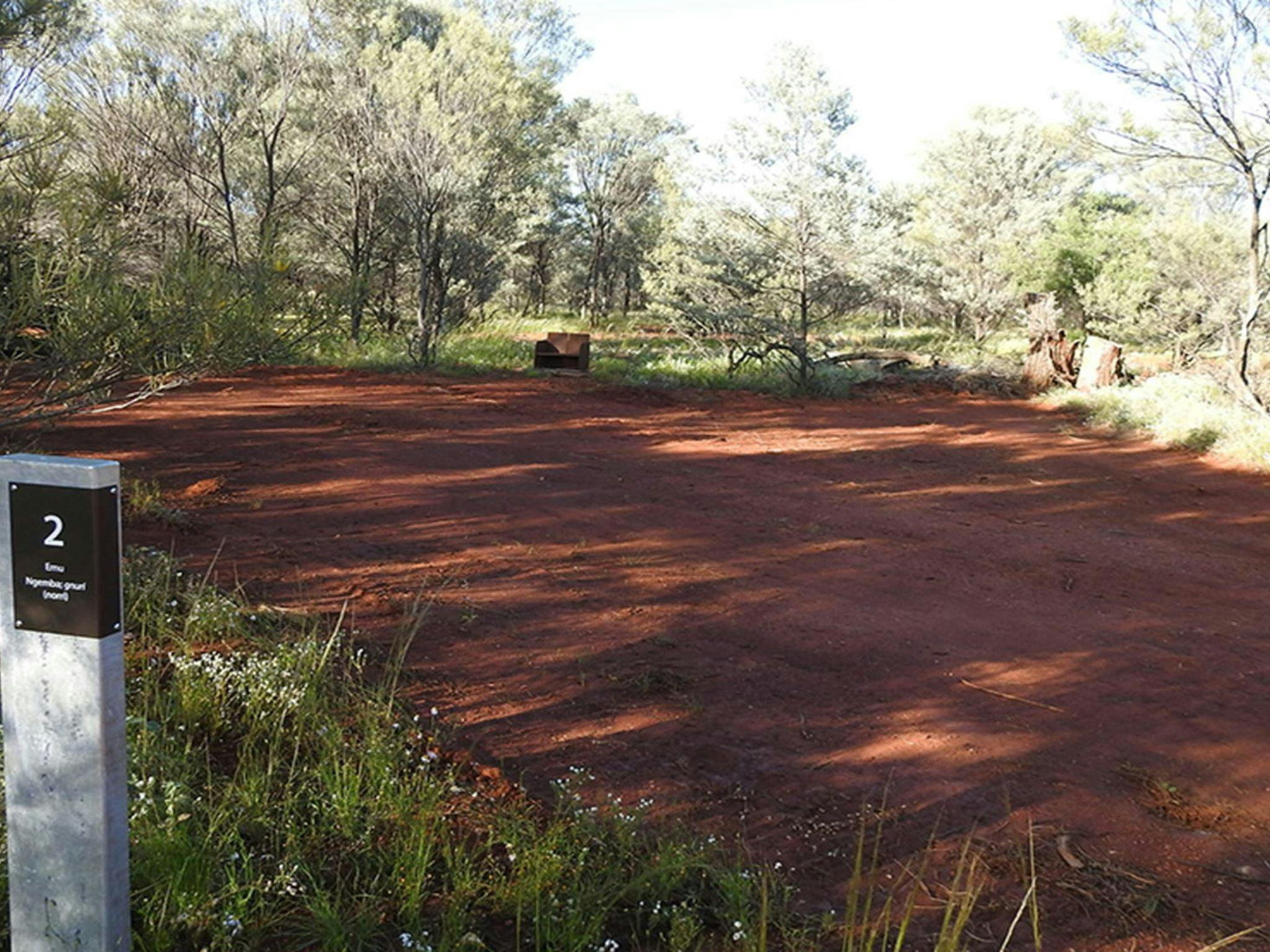 Photo of campsite number 2 surrounded by trees, grass and shrub at Dry Tank campground in Gundabooka