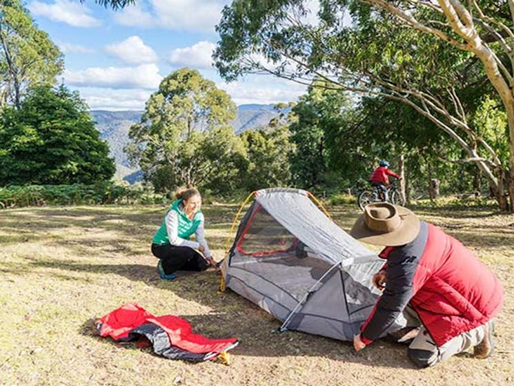 A couple pitch a tent at Dunphys campground, Blue Mountains National Park. Photo: Simone