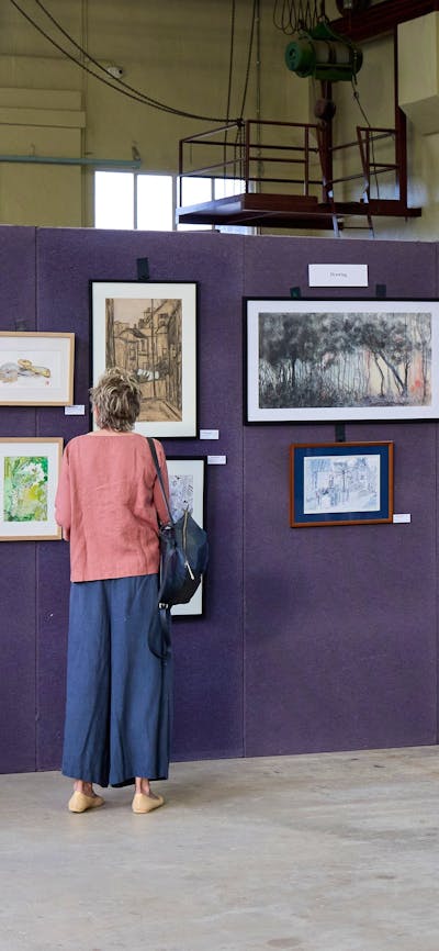 Visitors to the 2023 Artists Society of Canberra Spring Exhibition and sale browsing the artworks