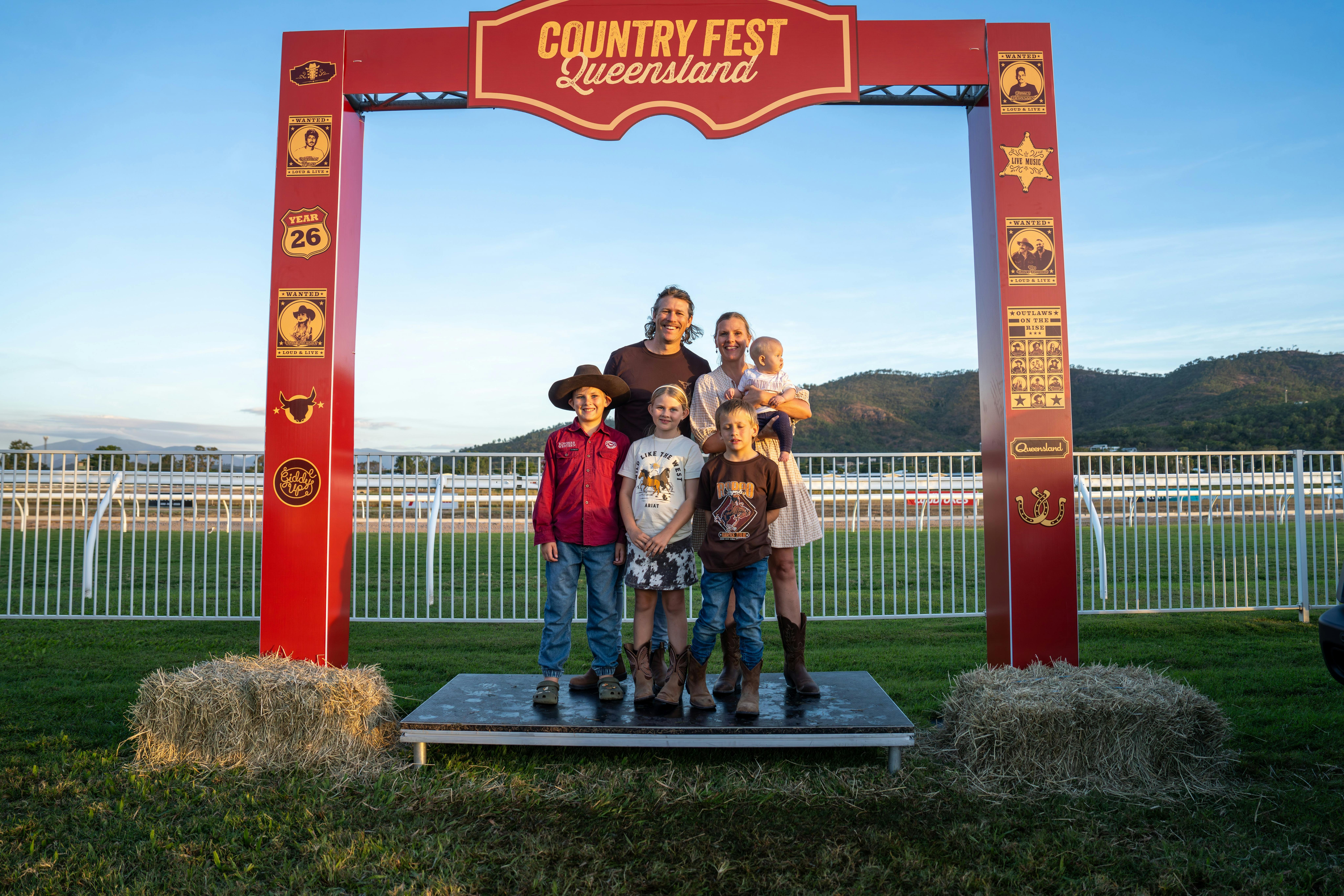 Family pose for a photo at the Country Fest photo opportunity