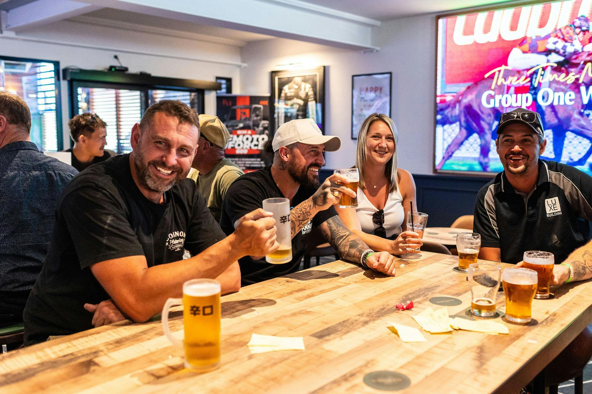 people with beers at table