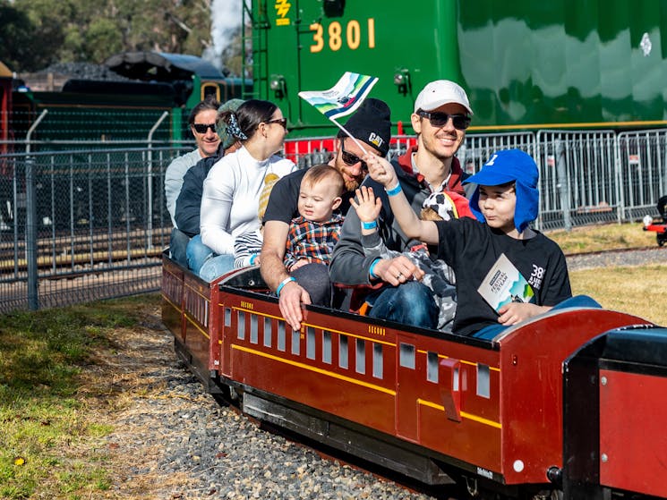 Family riding on a mini train