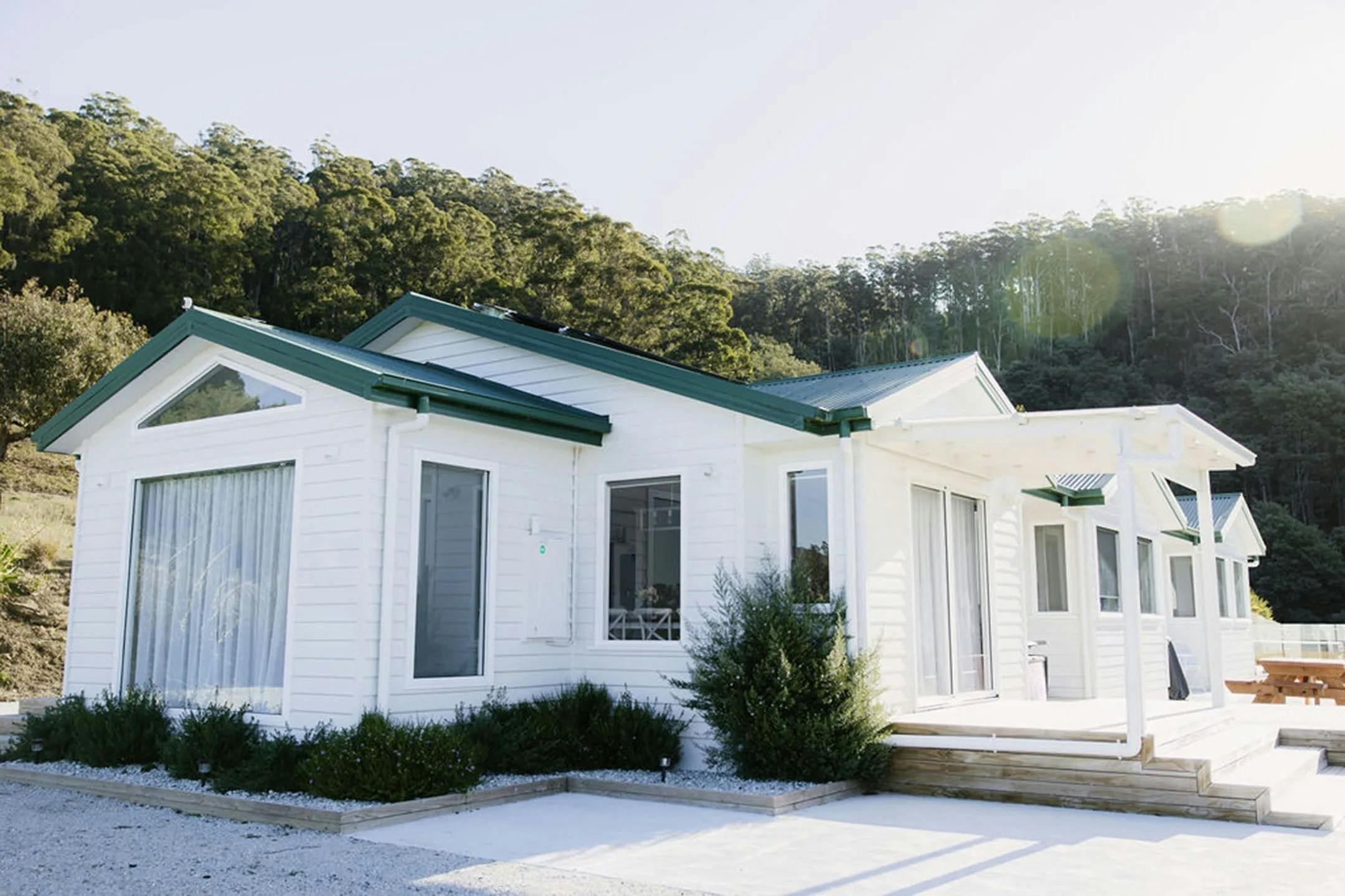 A house situated within green foliage backdrop.