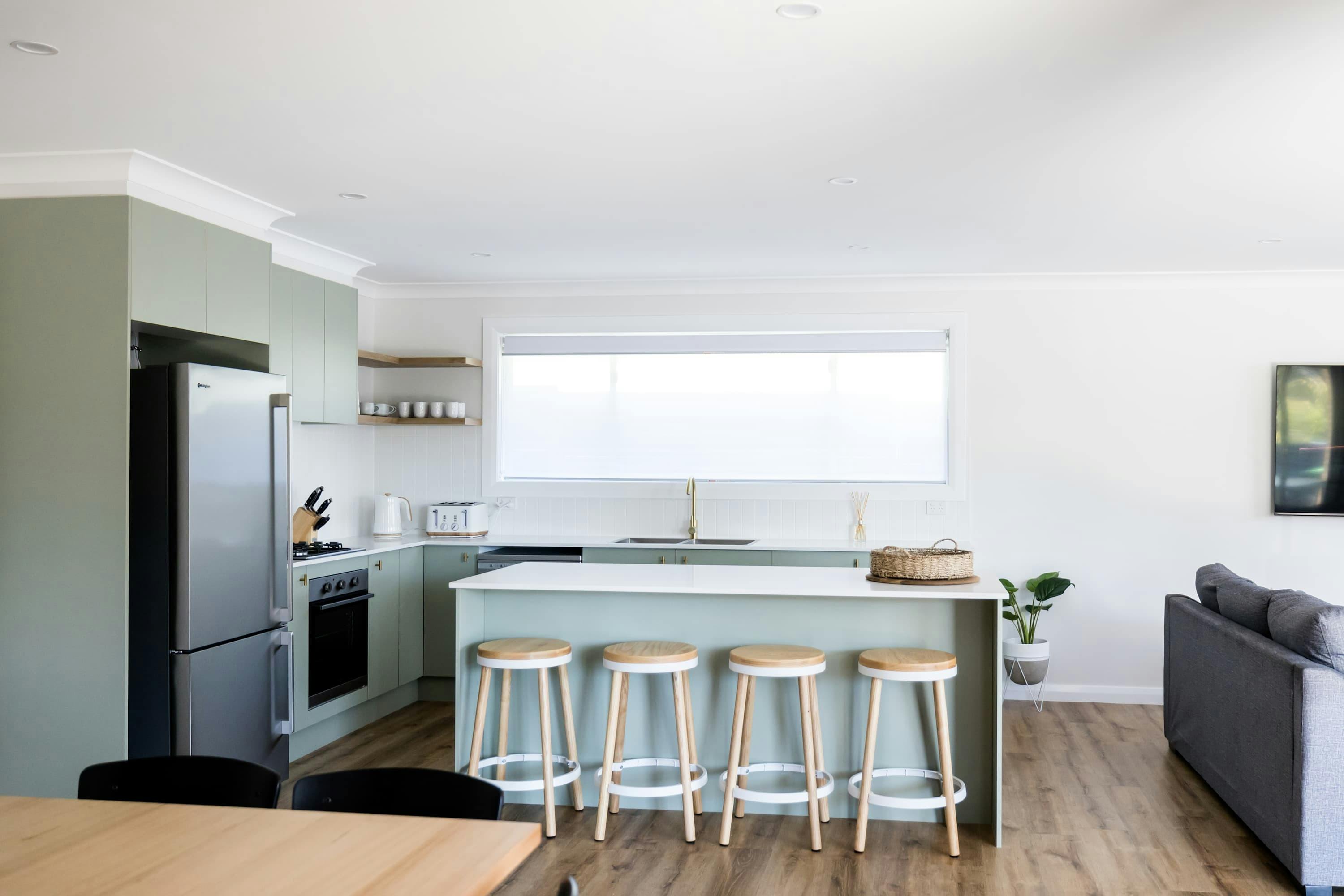 Modern kitchen with all the necessary appliances, bar stools.