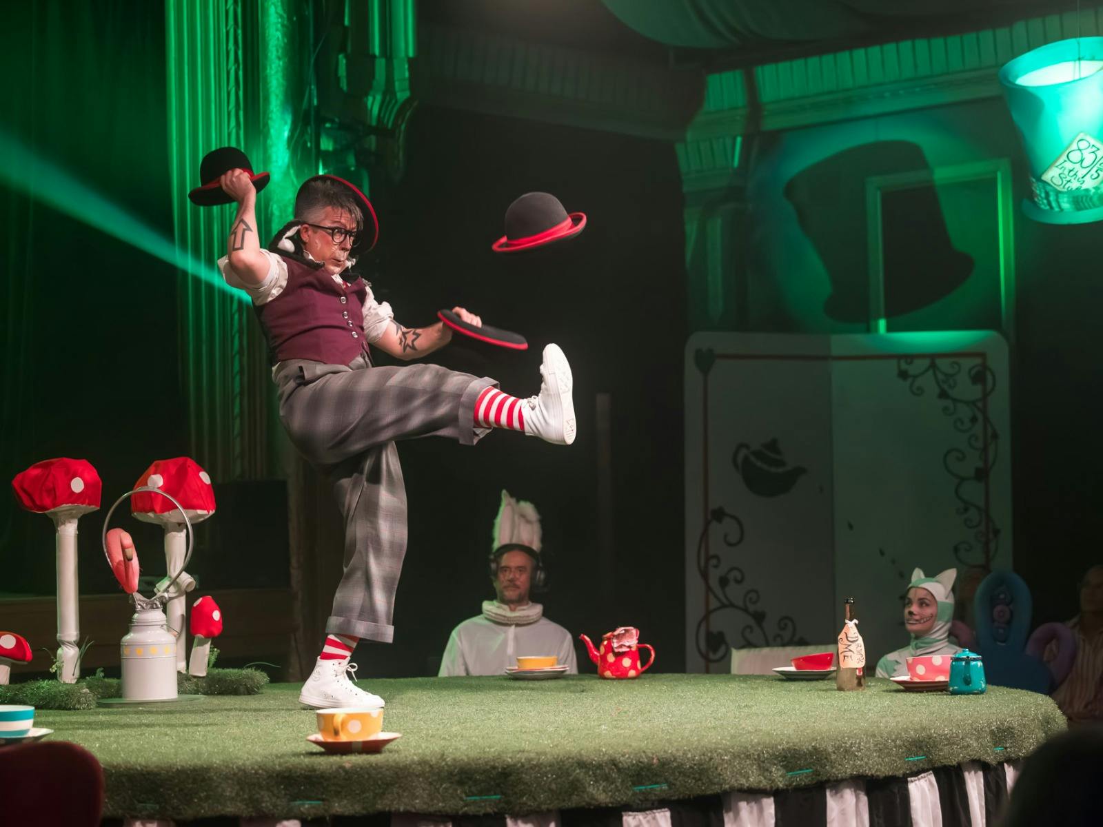 A performer juggles multiple hats