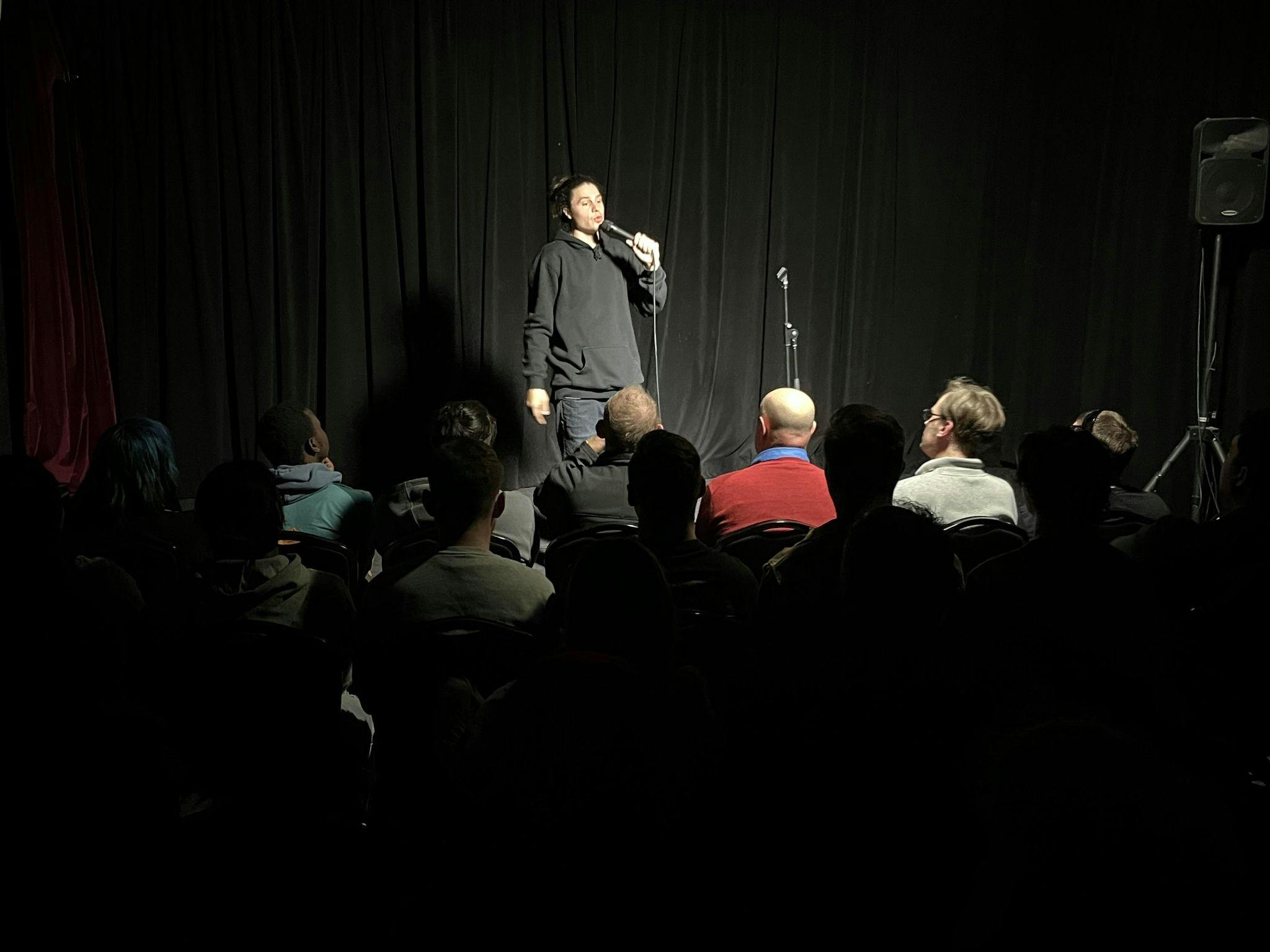 Comedian performing to an audience at Club Voltaire Comedy in North Melbourne
