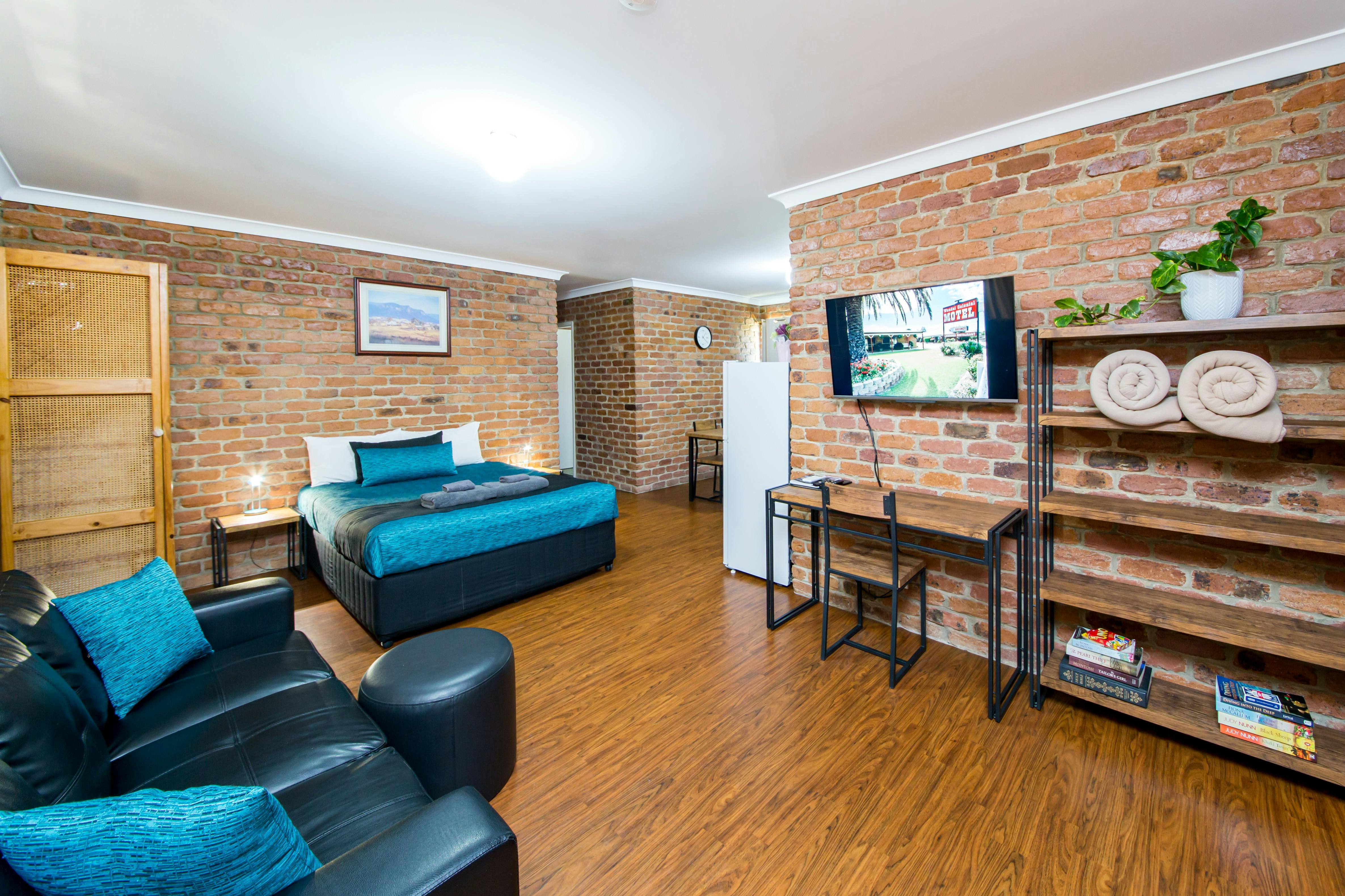 A Spacious 2 Room Family Unit with a Queen bed and 2 Single Beds, Lounge, Table & Chairs, Smart TV