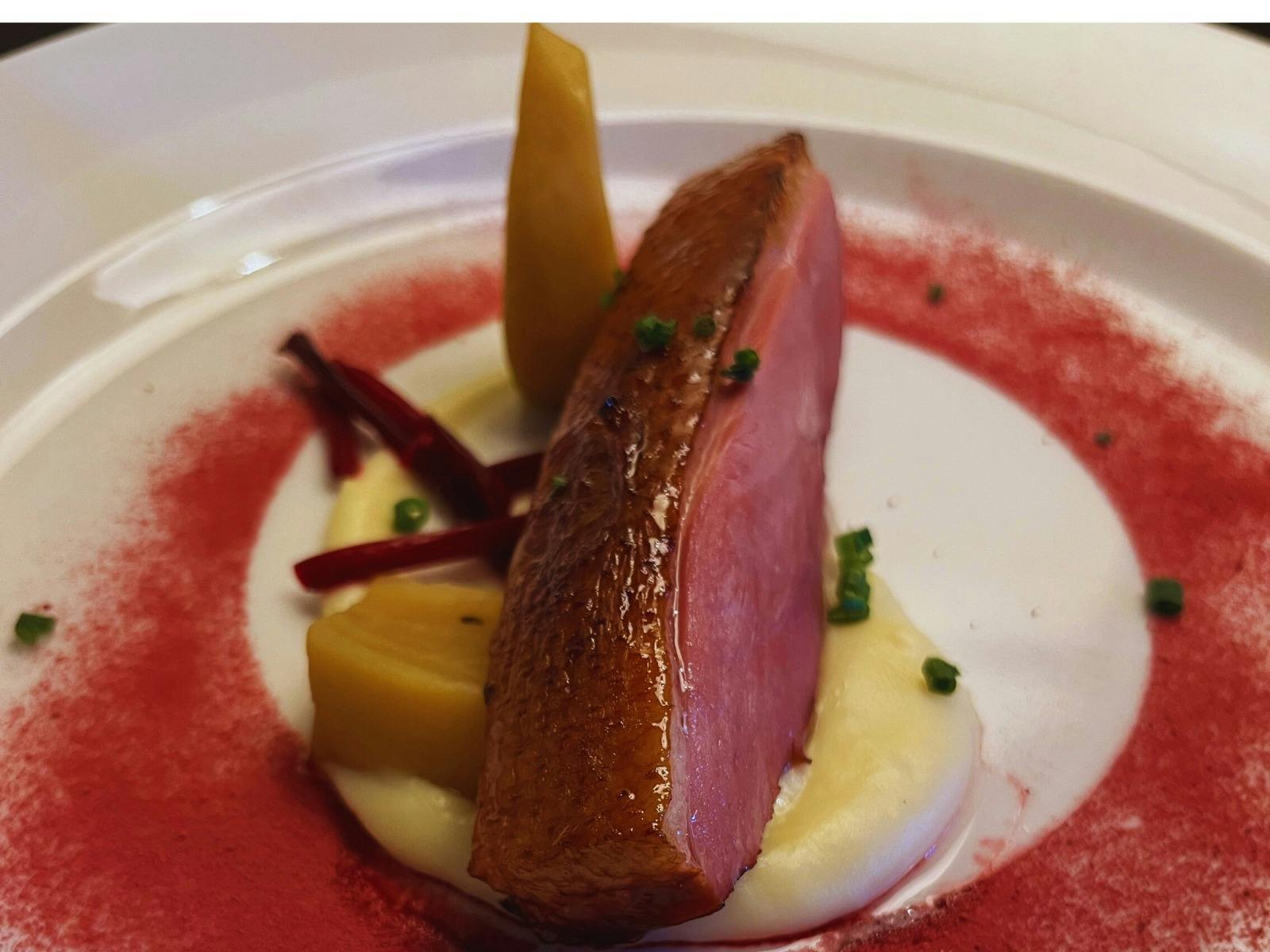 Seared Duck Breast Served with  parsnip cream, pickled vegetables, rhubarb puree, toasted walnuts,