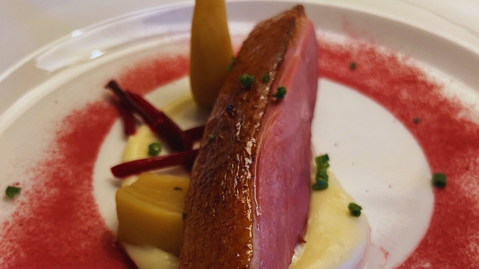 Seared Duck Breast Served with parsnip cream, pickled vegetables, rhubarb puree, toasted walnuts,