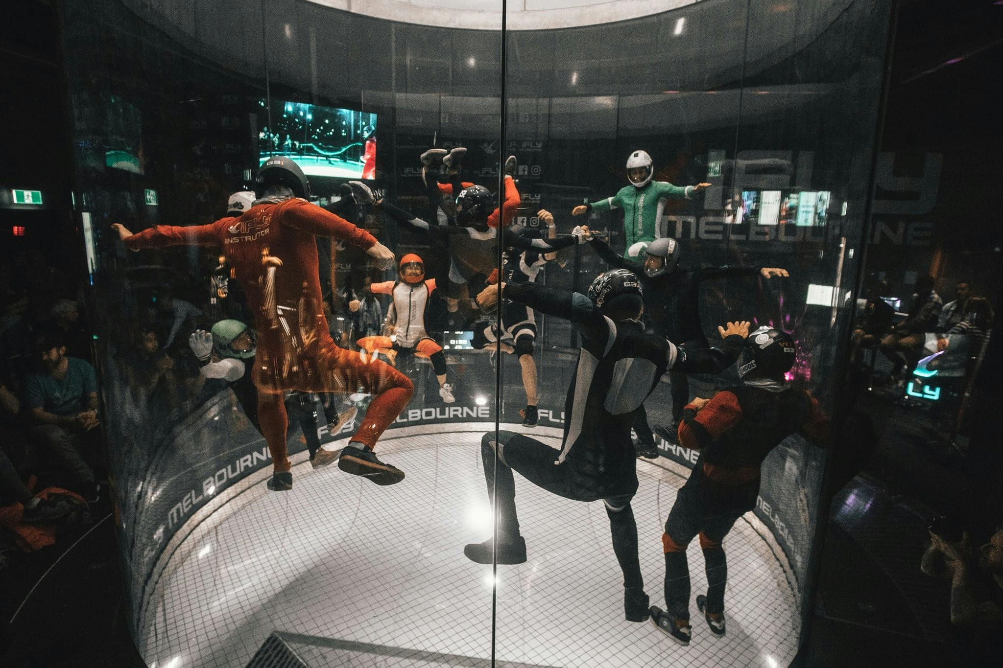 Team of experienced flyers in dynamic formation at iFLY Melbourne.