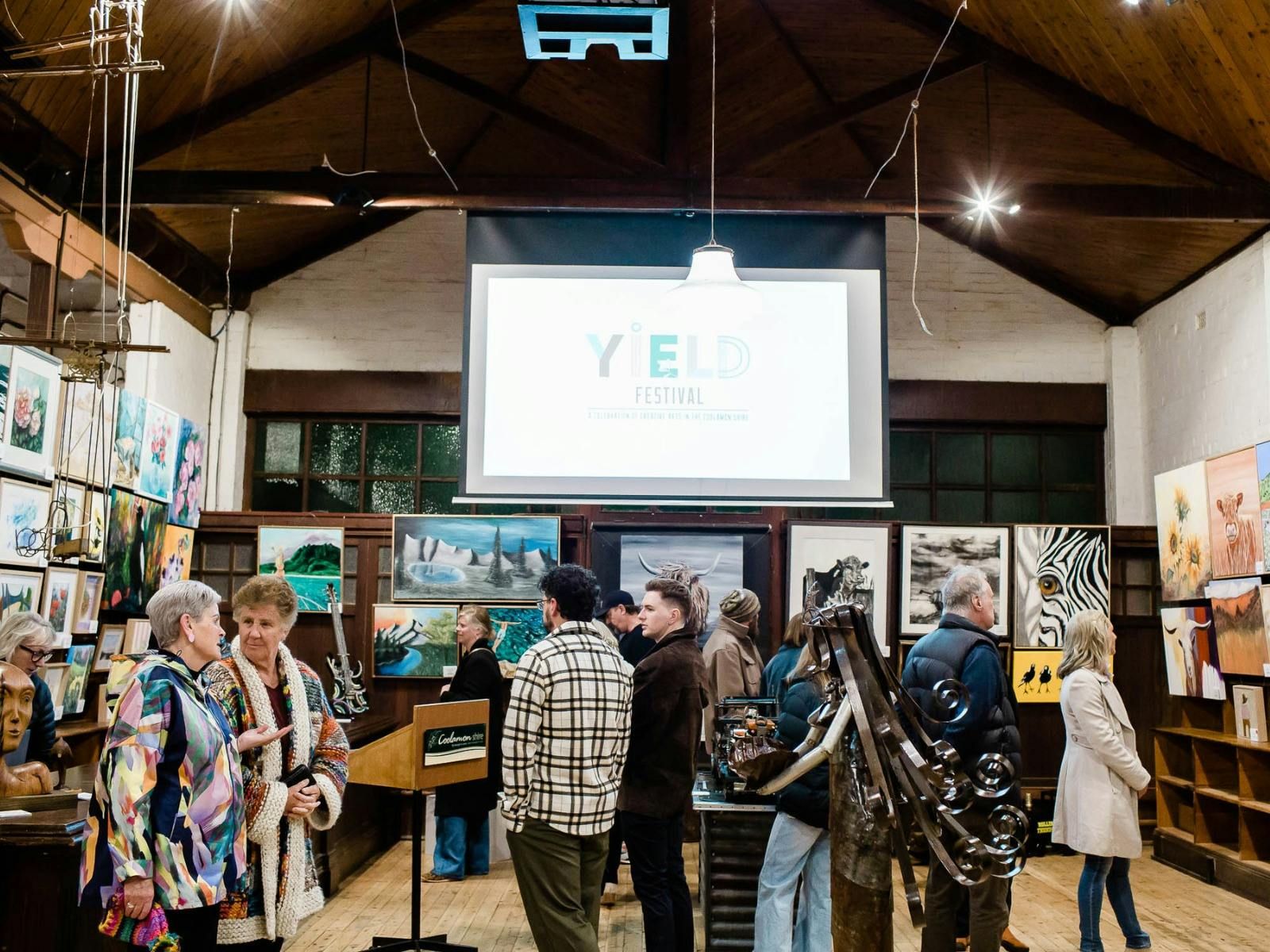 A group of people viewing the artworks on display