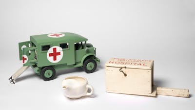 Objects including gas mask, replica ambulance, tea pot and medical