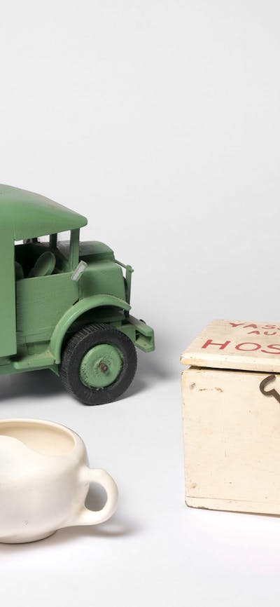 Objects including gas mask, replica ambulance, tea pot and medical