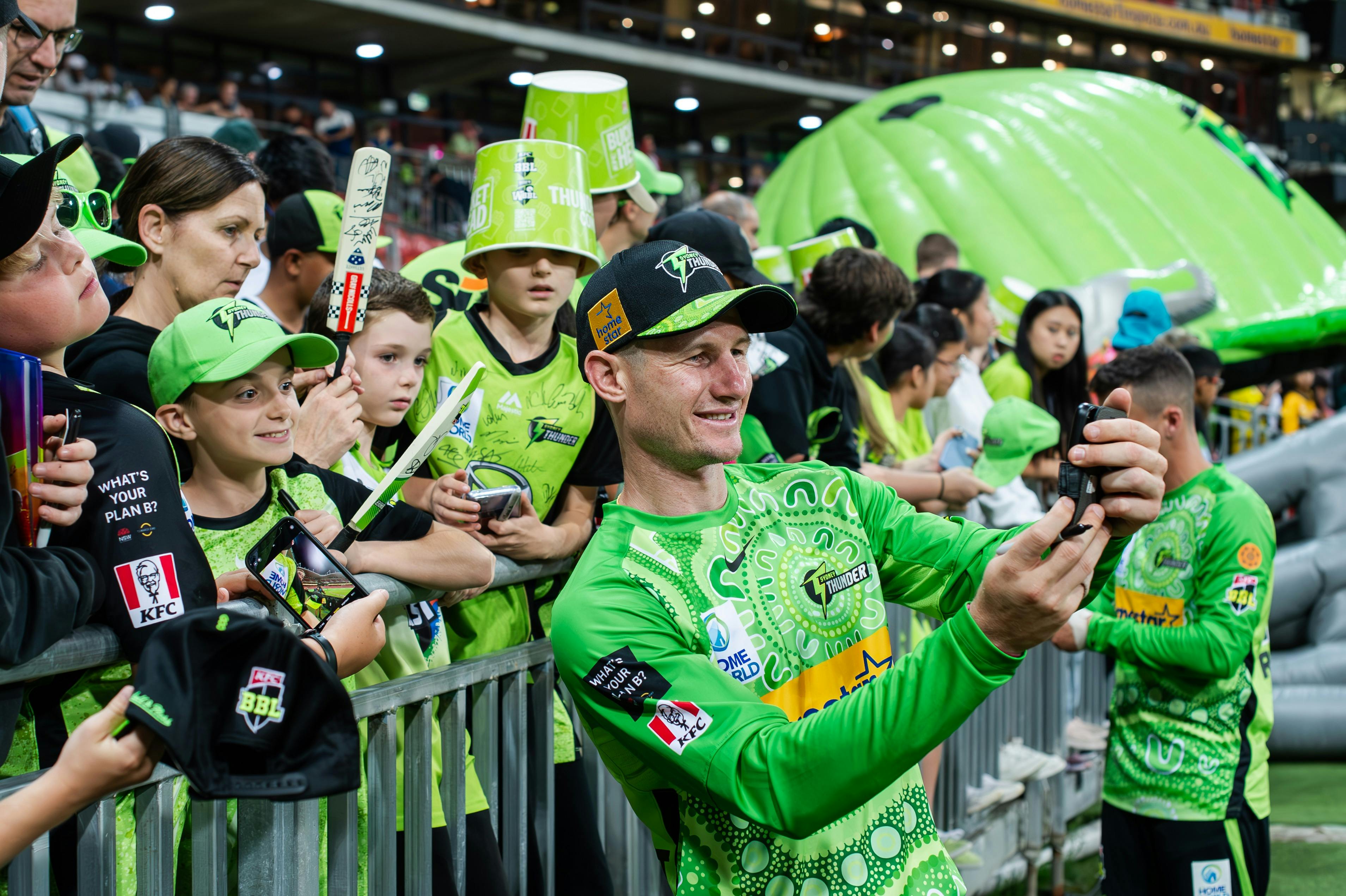 BBL Thunder player taking a selfie with a Thunder fan after the match