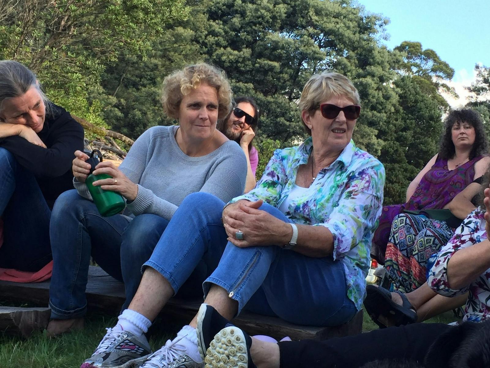 Women chatting around campfire