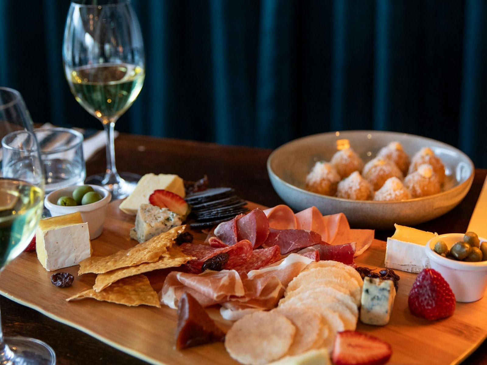 Selection of Tilba cheeses with membrillo, cornichons,  muscatels and Fedra olives