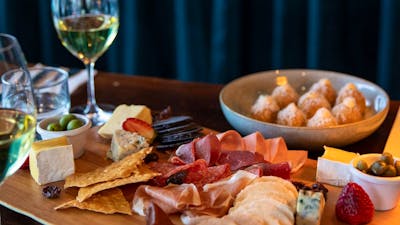 Selection of Tilba cheeses with membrillo, cornichons, muscatels and Fedra olives