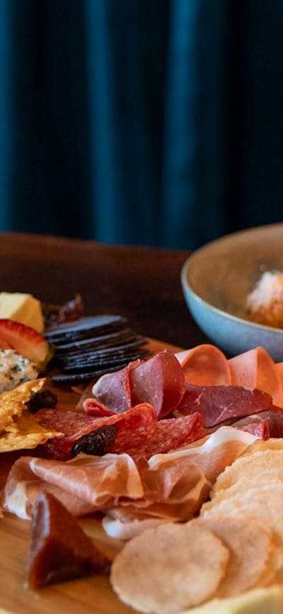 Selection of Tilba cheeses with membrillo, cornichons, muscatels and Fedra olives