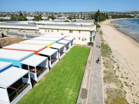 Six apartments showing front decks, lawned area, Parnkalla Trail and foreshore beach.