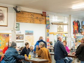 Patrons in the hotel bar are socialising together.
