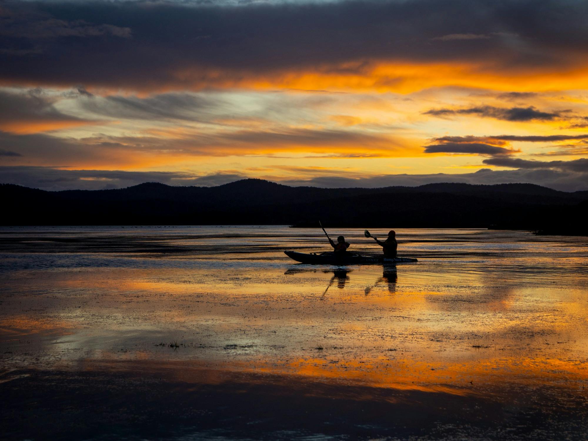 Golden sunset with guests paddling