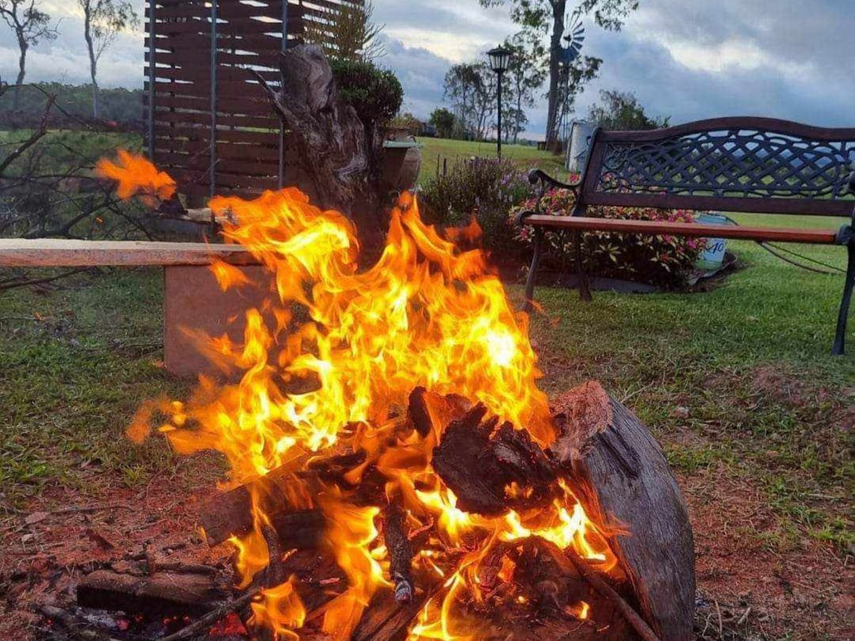 sit around the outdoor fire pit at the hitching rail retreat in the beautiful nature surrounds