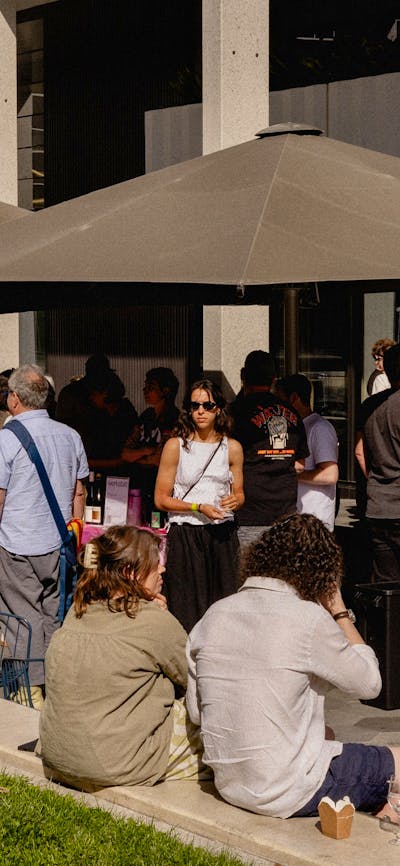 People enjoying Frenzy 2024 tasting wine and sharing community
