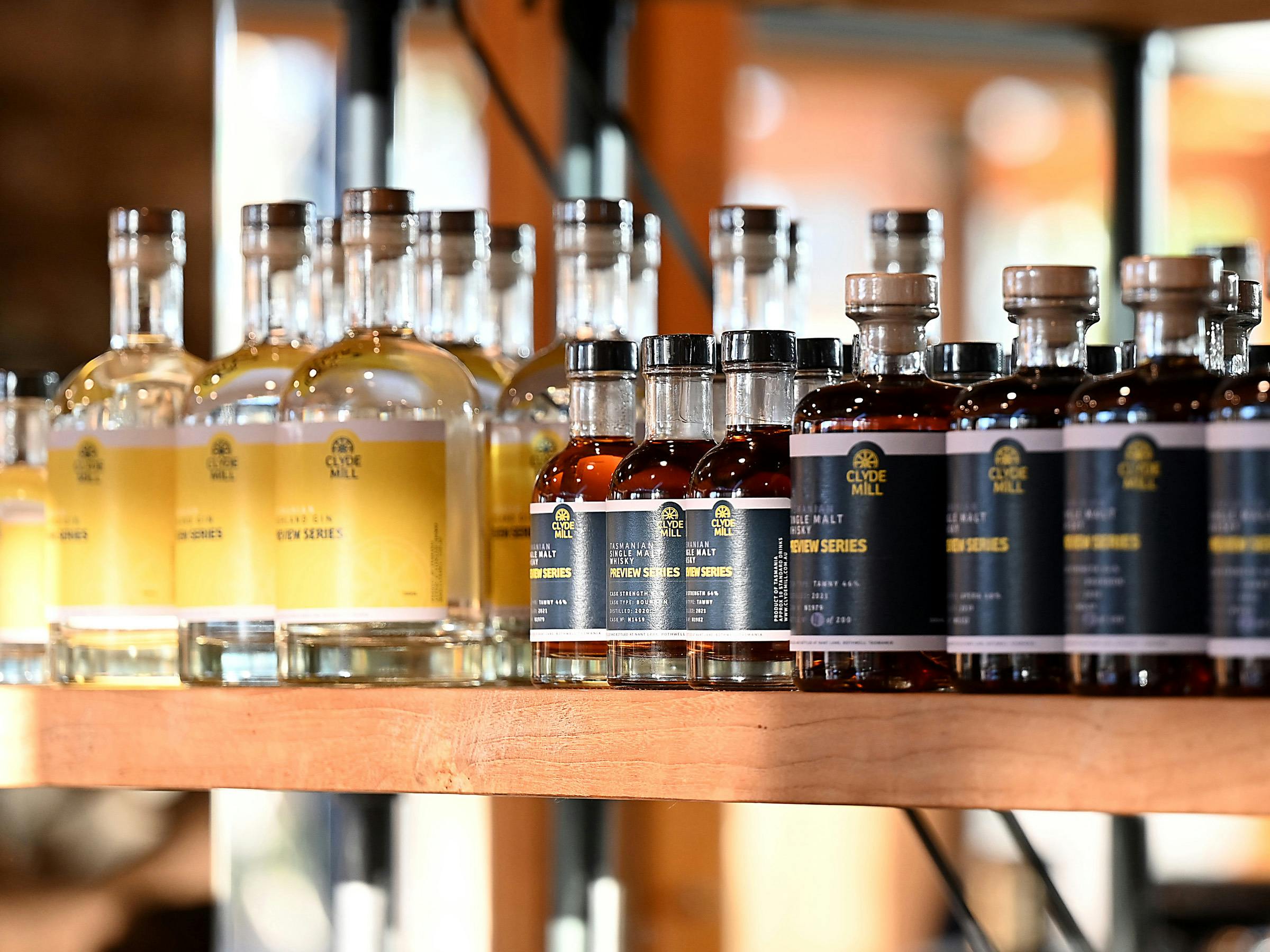 Clyde Mill whisky and gin bottles displayed on a shelf.