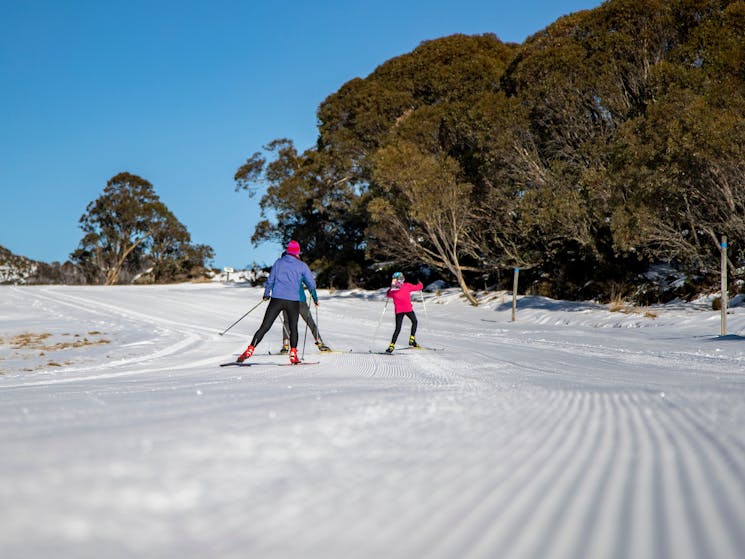 Two adults and a child XC Skiing