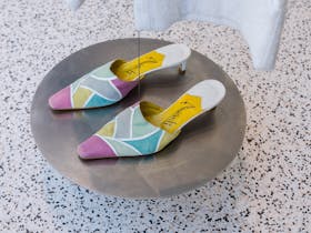 Image of multicoloured mules in the window display