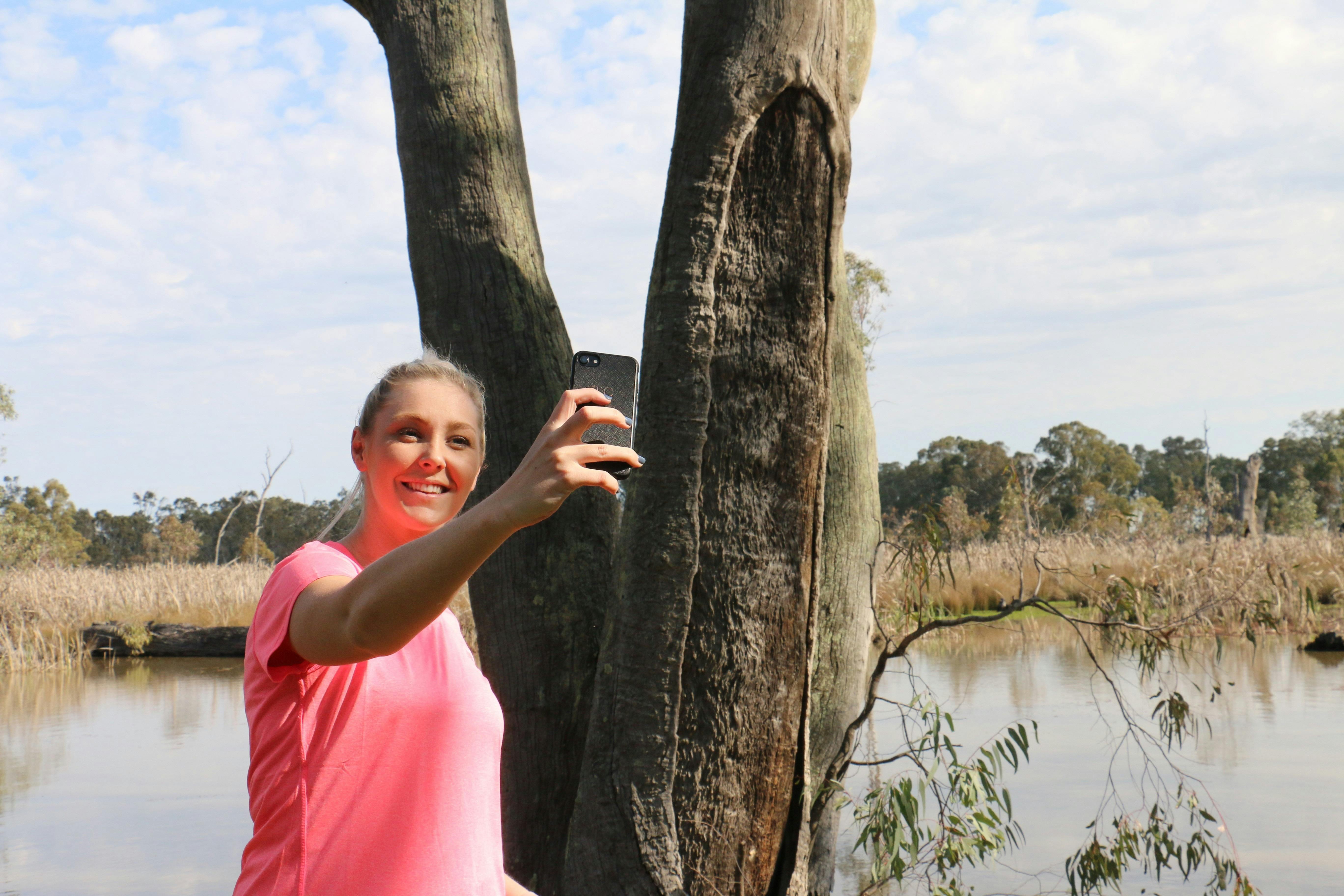 Lady taking selfie of a canoe tree