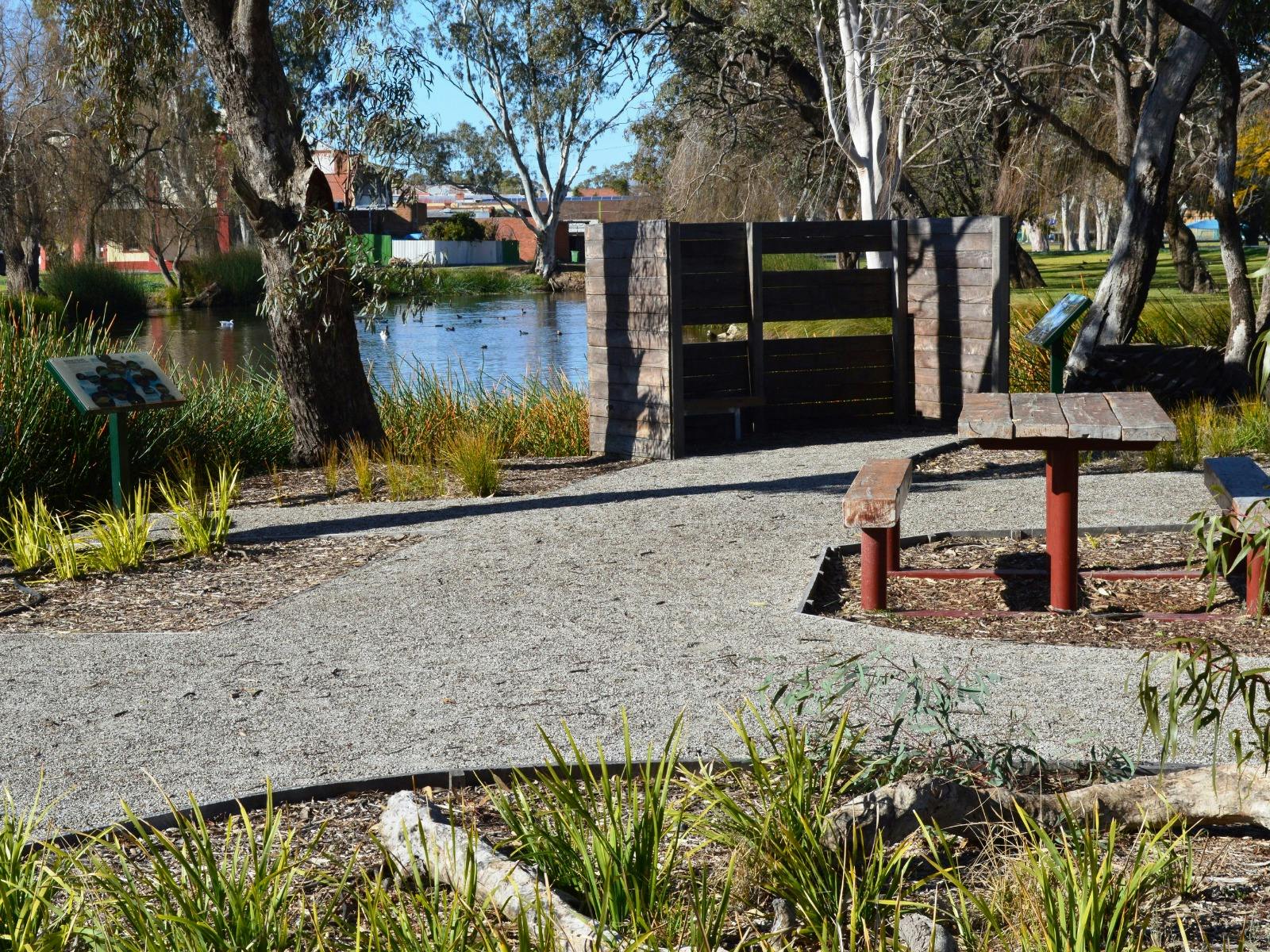 A park with path, bird hide and seating area